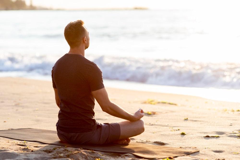 A man meditates as a part of his morning ritual for weight loss